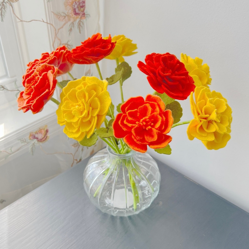 a glass vase filled with colorful flowers on top of a table