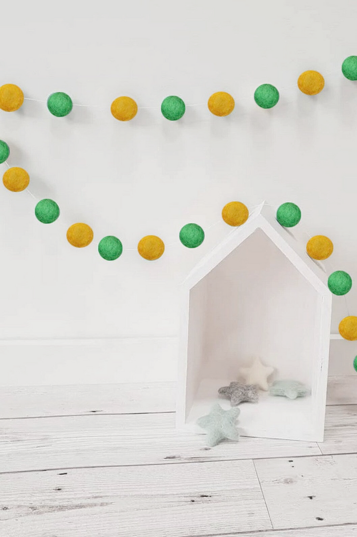 a white dog house with green and yellow decorations